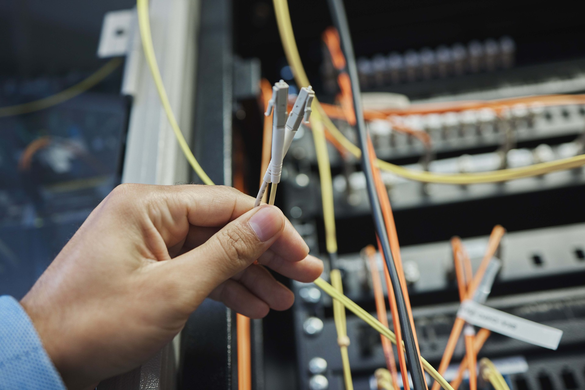 Shot of an unrecognizable woman working on cables in a server room